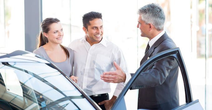 young couple buying a new car